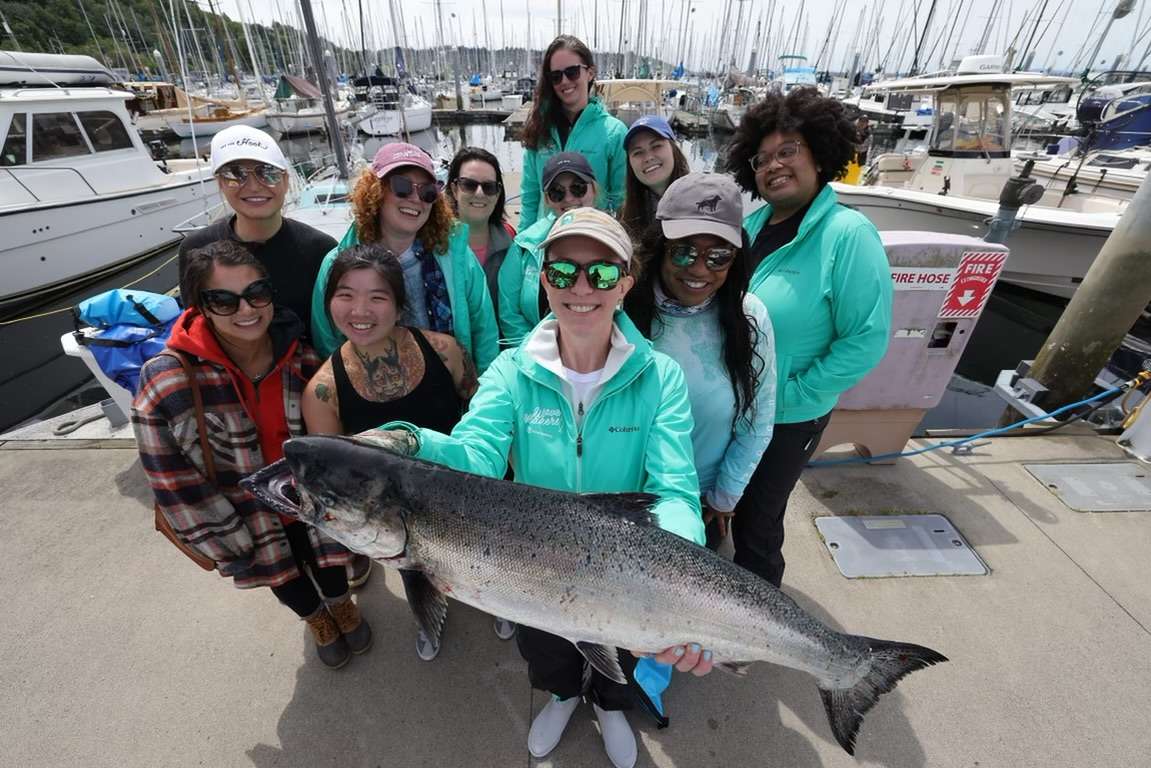 Monthly Fishing Opportunities in Seattle Group of people smiling after a successful fishing charter in Seattle